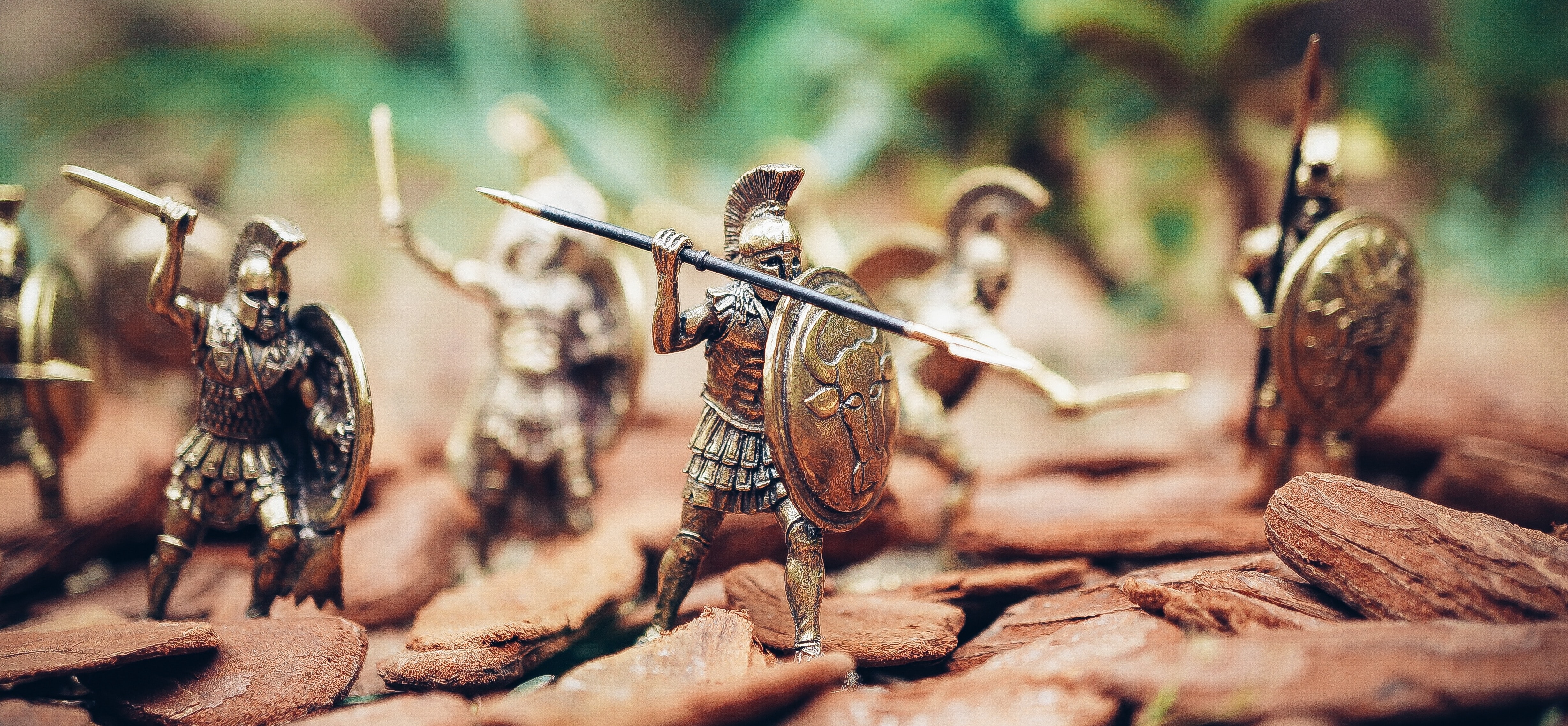 A spartan soldier, holding a shield and a spear, about to head into war.